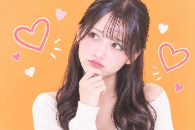 顎に手を当てて首を傾げる女性